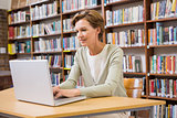 Focus teacher using laptop at library