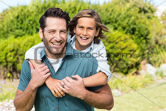 Father and son smiling at camera