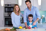 Happy family preparing vegetables together