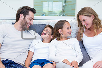 Happy family smiling at each other