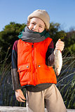 Cute boy holding fish