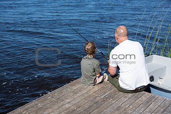 Happy man fishing with his son