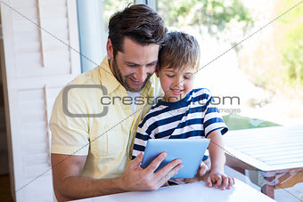 Father and son using tablet pc