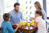Happy family having breakfast together