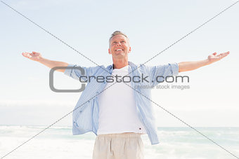 Handsome man with arms outstretched