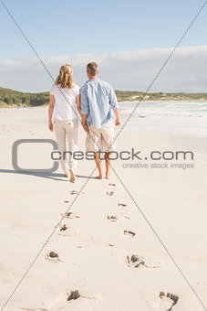 Happy couple walking holding hands