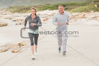Fit couple jogging to camera