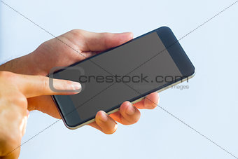 Hand holding a black smartphone