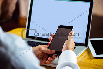 Man using laptop and smartphone