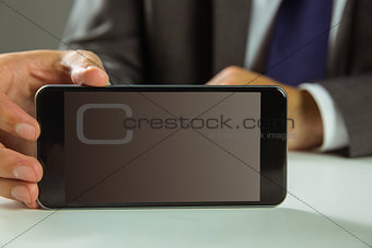 Businessman showing his smart phone
