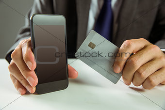 Businessman using smartphone for online shopping