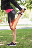 Highlighted leg of stretching woman