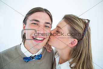 Pretty geeky hipster giving boyfriend kiss on the cheek