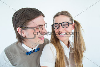 Geeky hipster couple smiling at each other