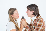 Happy geeky hipsters singing with microphone