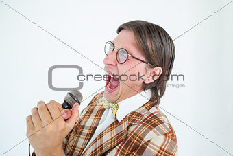 Happy geeky hipster singing with microphone