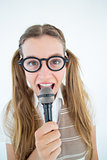 Happy geeky hipster singing with microphone