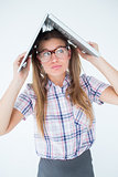 Geeky hipster holding her laptop over her head
