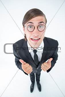 Geeky businessman looking at camera thumbs up