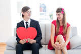 Cute geeky couple with red heart shape