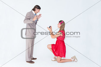 Pretty hipster on bended knee doing a marriage proposal to her boyfriend