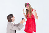 Hipster on bended knee doing a marriage proposal to his girlfriend