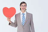 Geeky businessman smiling and holding heart card