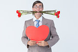 Geeky businessman offering valentines gifts