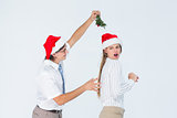 Geeky hipster running away from a man with mistletoe