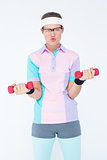 Geeky hipster girl lifting dumbbells