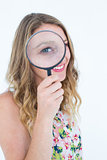 Smiling woman holding magnifying glass