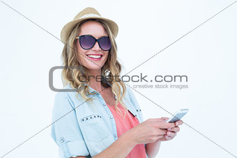 Smiling woman texting with her smartphone