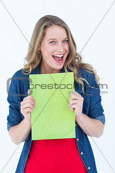 Smiling student holding notebook