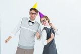 Geeky hipster couple wearing a party hat