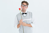 Geeky hipster holding a red rose