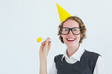 Geeky hipster in party hat with horn