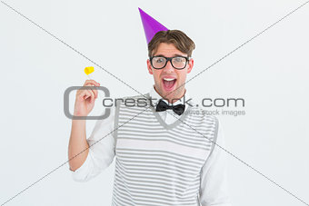 Geeky hipster in party hat with horn