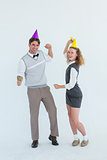 Geeky couple dancing with party hat