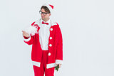 Geeky hipster in santa costume looking at beard