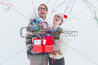 Excited geeky hipster couple looking at confetti
