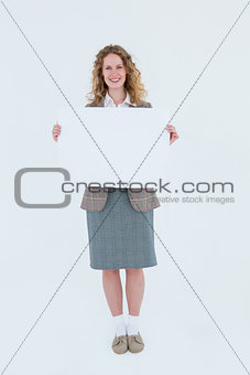 Hipster woman showing poster smiling at camera