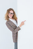 Hipster woman pointing poster smiling at camera