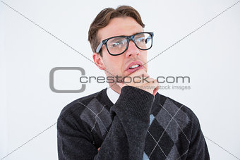 Geeky hipster thinking with hand on chin
