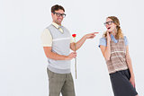 Geeky hipster holding rose and pointing his girlfriend