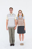 Smiling geeky hipster couple holding hands