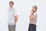 Geeky hipster couple looking at camera