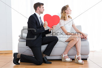 Businessman giving heart card to his girlfriend