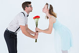 Geeky hipster couple holding roses and kissing