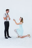 Hipster woman doing a marriage proposal to her boyfriend