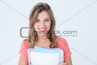 Smiling hipster holding notebook